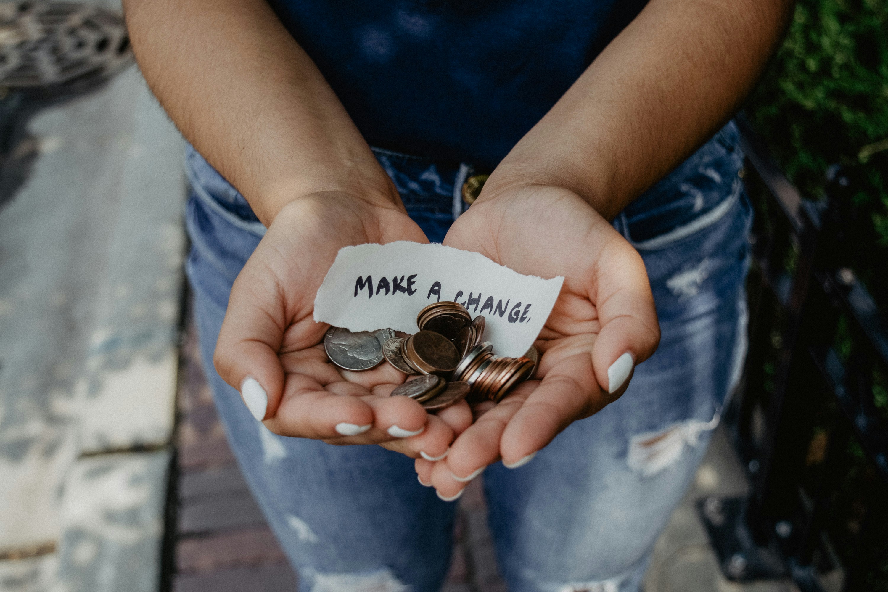 Hands holding coins to make a change